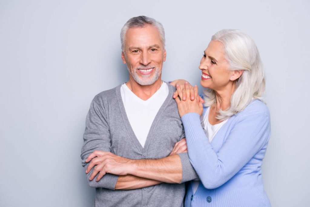 Elderly couple enjoying their dental implants that last a lifetime.